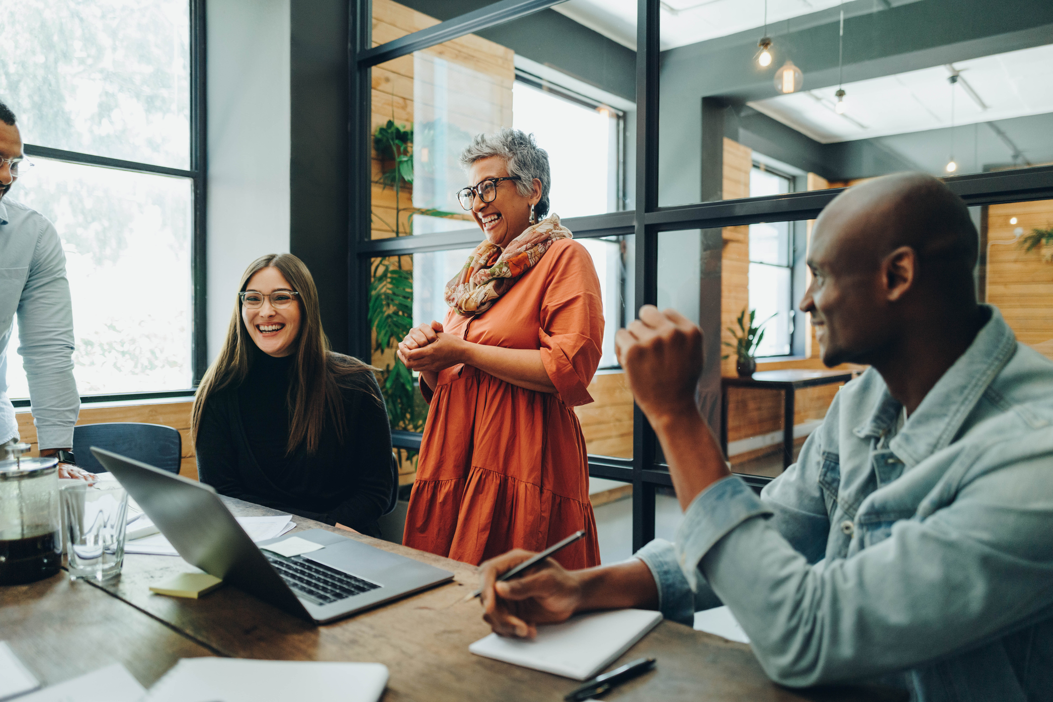 A combination of hourly, contracted and salaried employees smiling about accessing their earned wages on-demand.