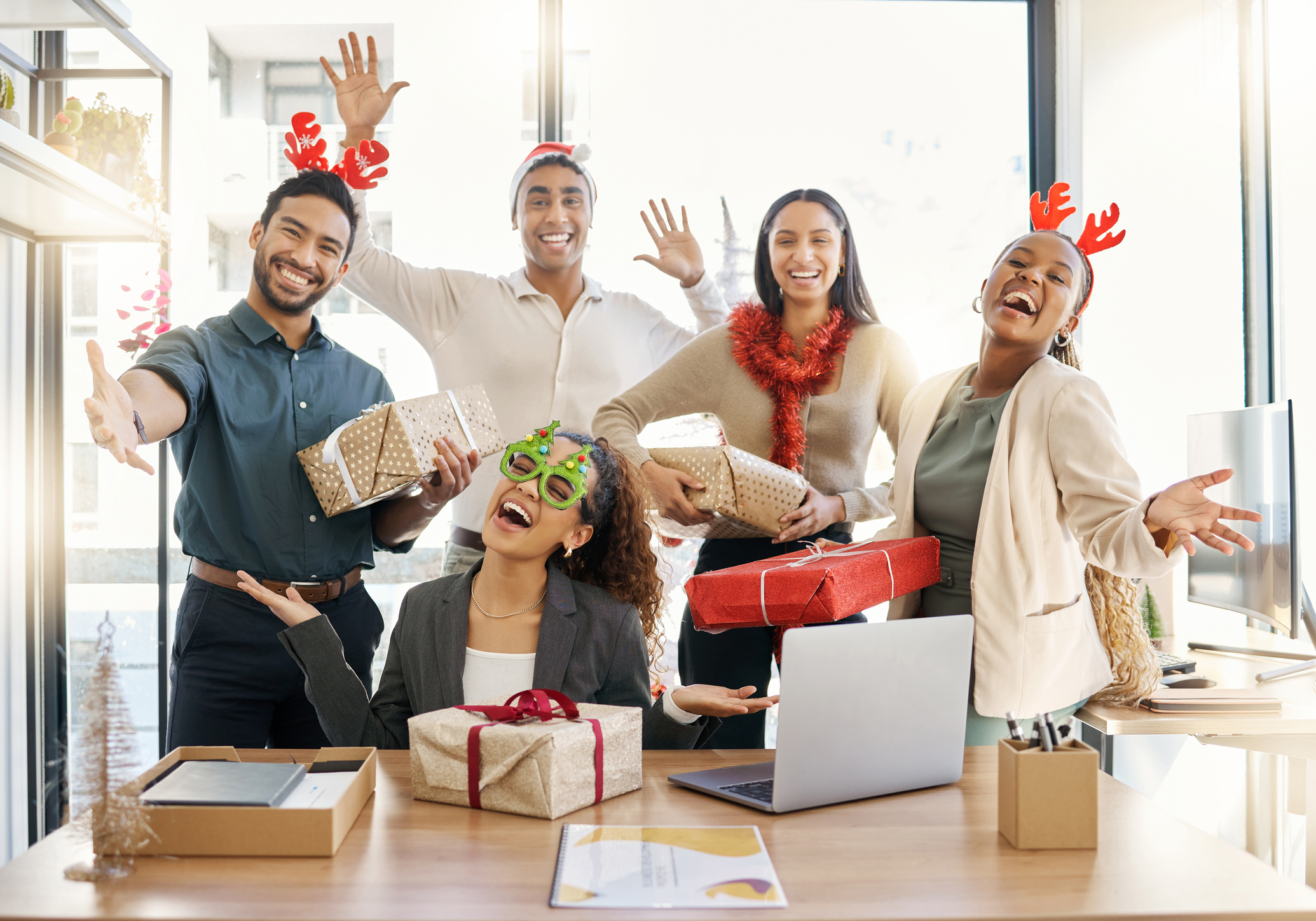 A group of employees celebrating the employee holiday gift of earned wage access.