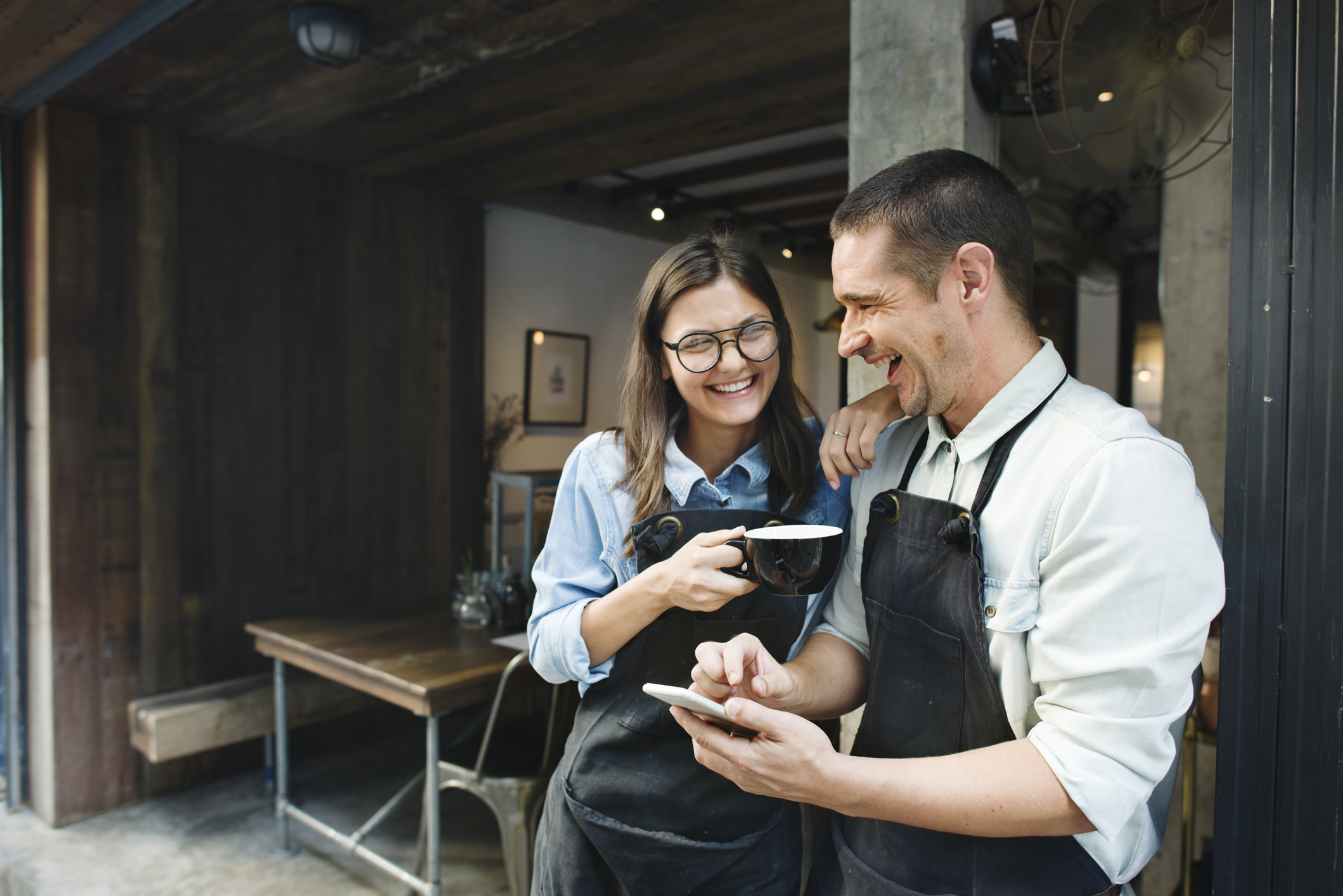 two employees getting their electronic tips on their mobile phone