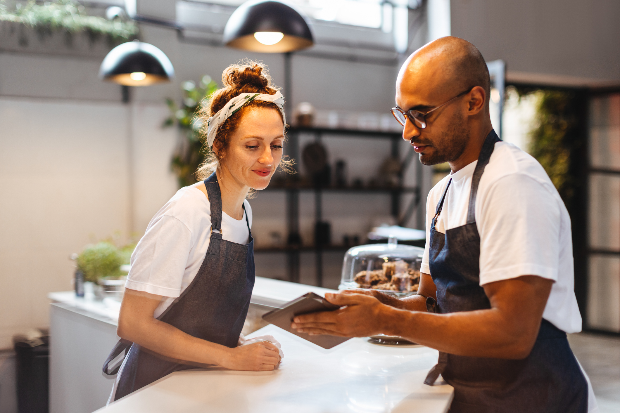 gen z restaurant workers looking at a mobile device