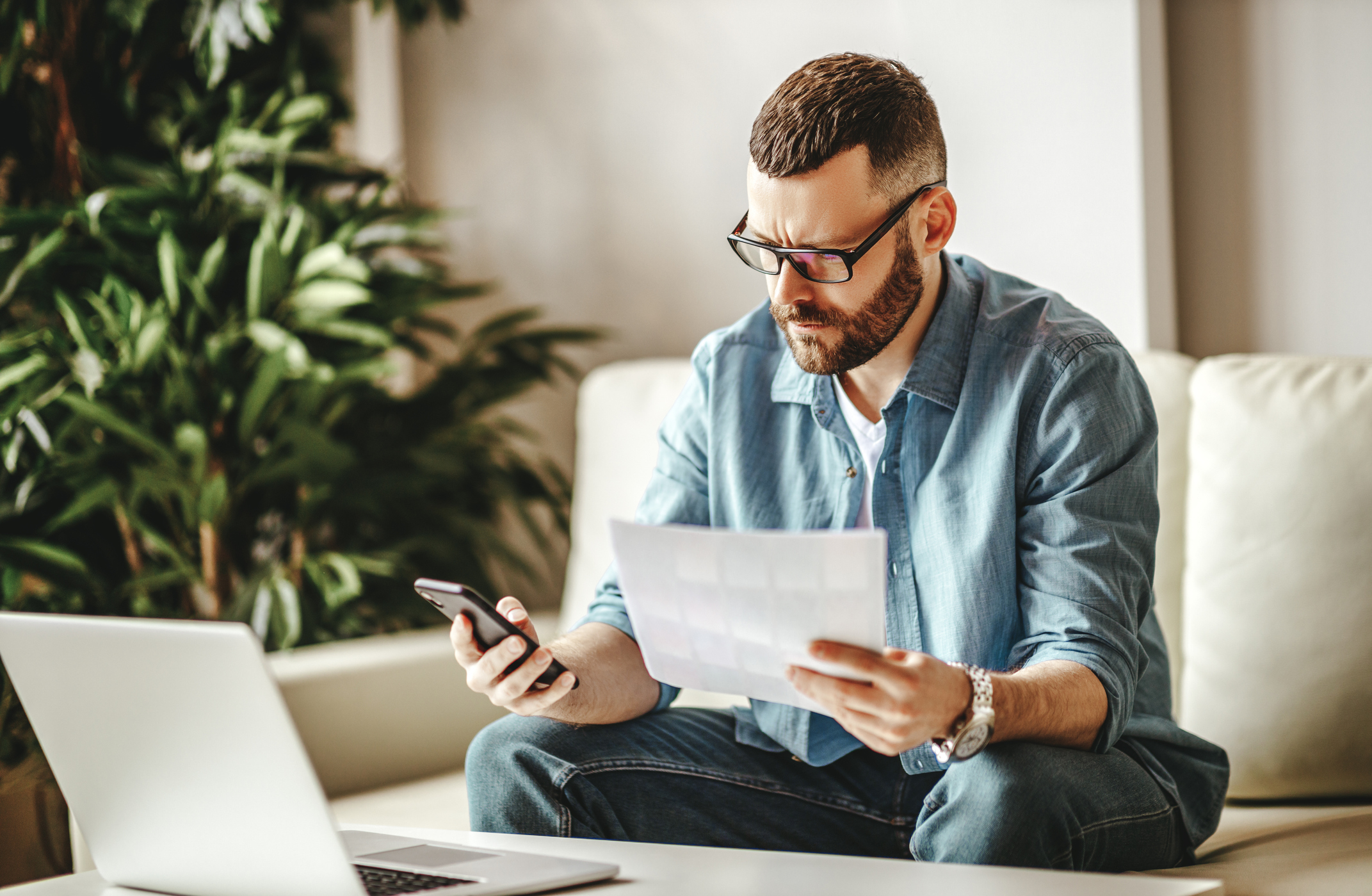Employee on mobile phone reviewing document