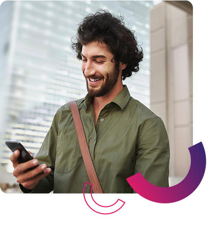 young man smiling at his phone