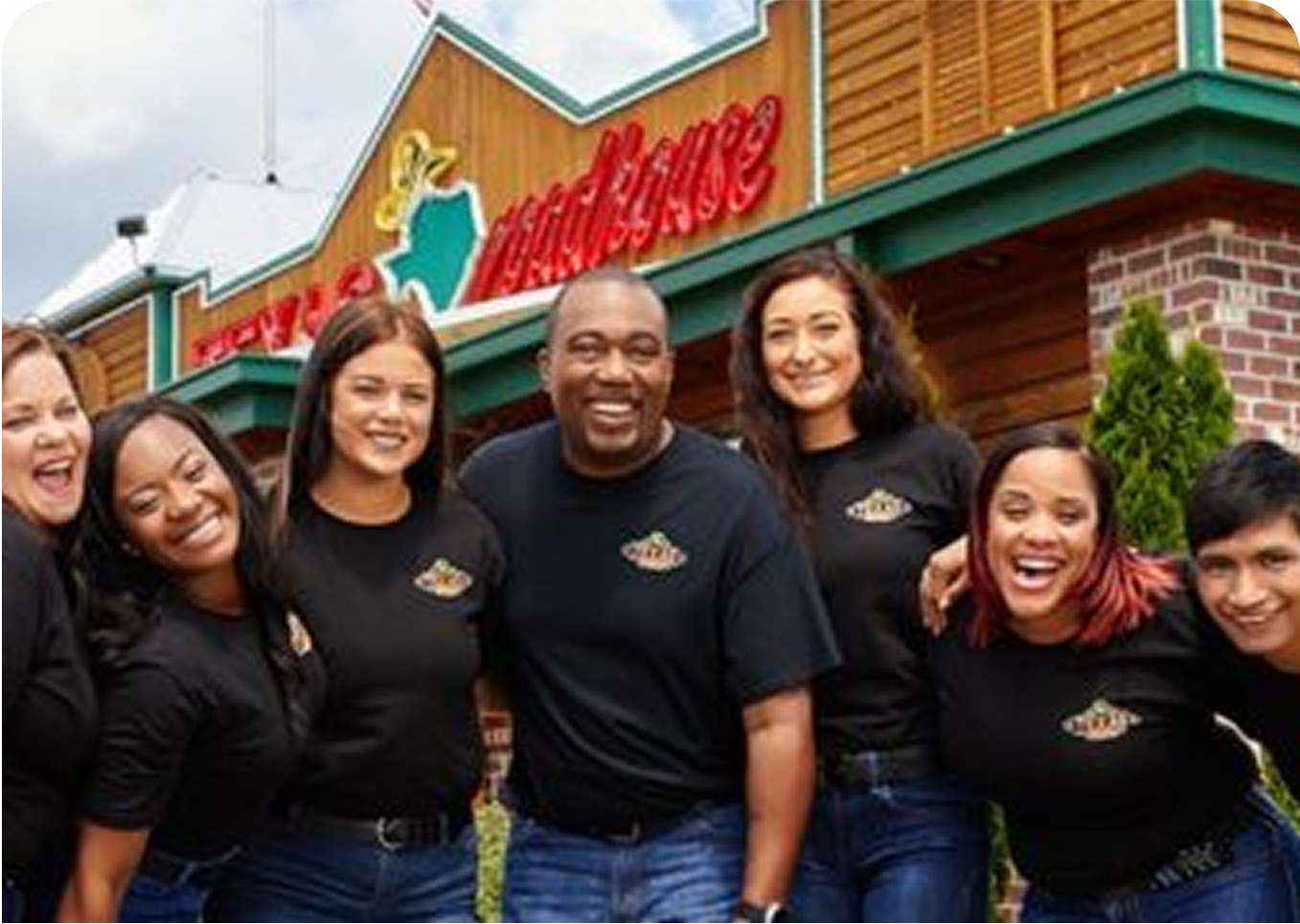 texas roadhouse employees outside restaurant smiling