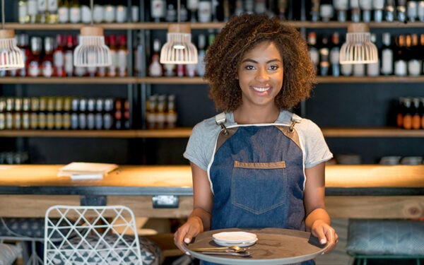 happy young female server holding serving tray