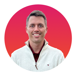 Man with half zip sweater smiling