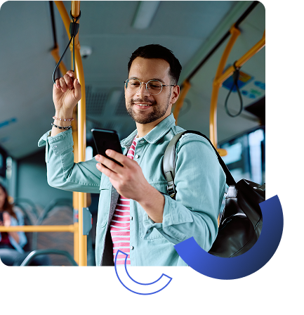 young happy male riding bus looking at phone