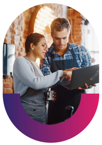 cafe employees looking at laptop together