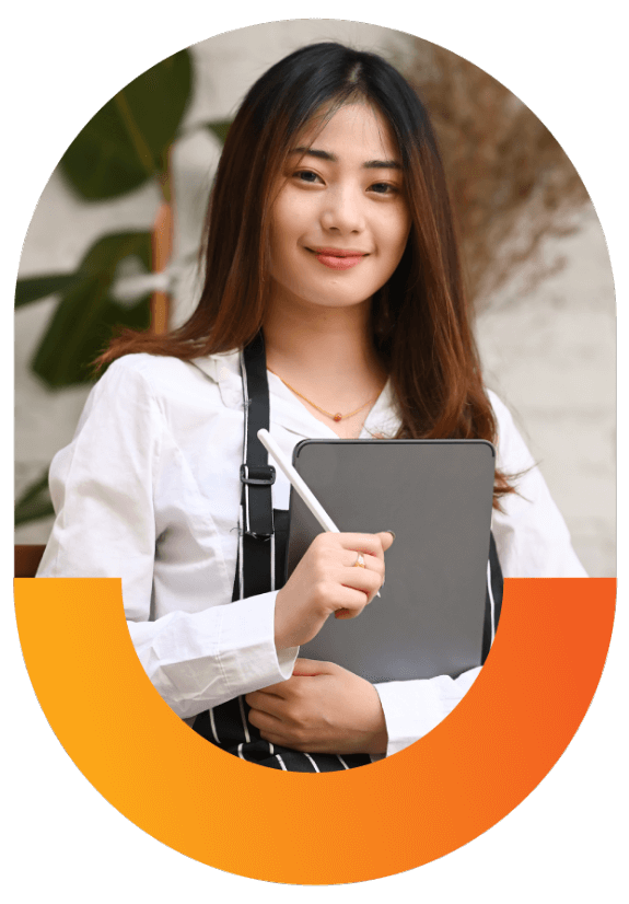 young woman wearing apron holding tablet and pen